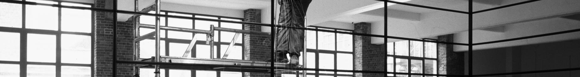 person standing on top of scaffolding inside a building