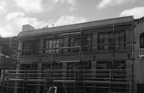 black and white image of a building with scaffolding set up