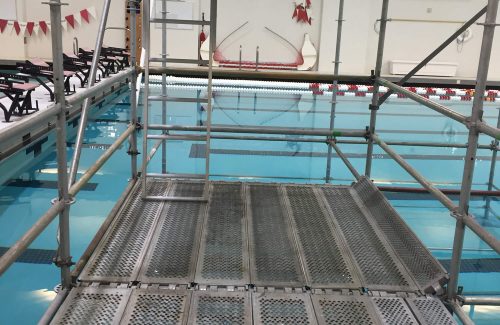 scaffolding set up in a large indoor swimming pool