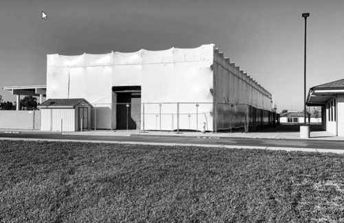 black and white image of shrink wrap around a rectangular building